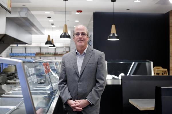 Jack Hartung posing for a photo at a Chipotle location in Chicago.